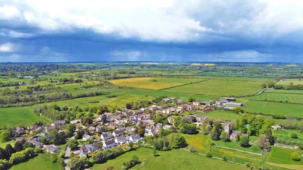 Shipton Moyne Village With Approaching Storm